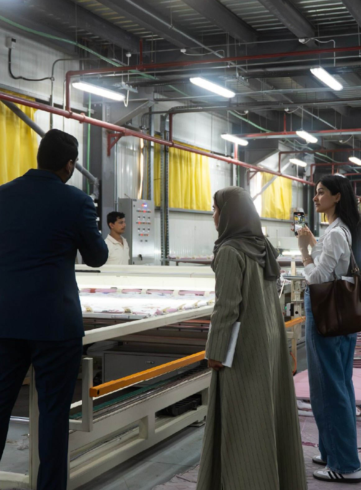 Asma photographing production in a factory in Doha’s Industrial Area